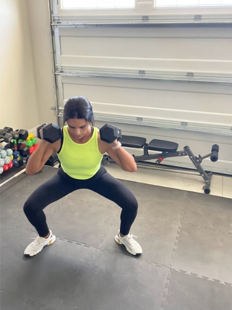 sumo squat pulse with dumbbells for glutes