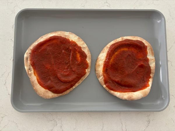 adding the pizza sauce
