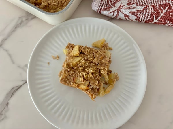 eating a piece of Apple Cinnamon Oatmeal Bake one piece of Apple Cinnamon Oatmeal Bake on a plate