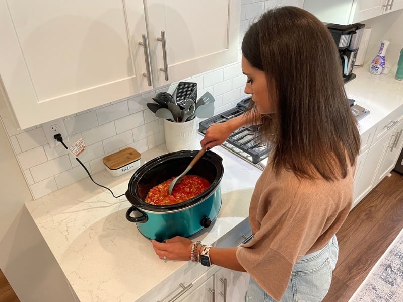stirring the chili in the crockpot